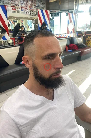 Beard trim paired with a tight skin fade